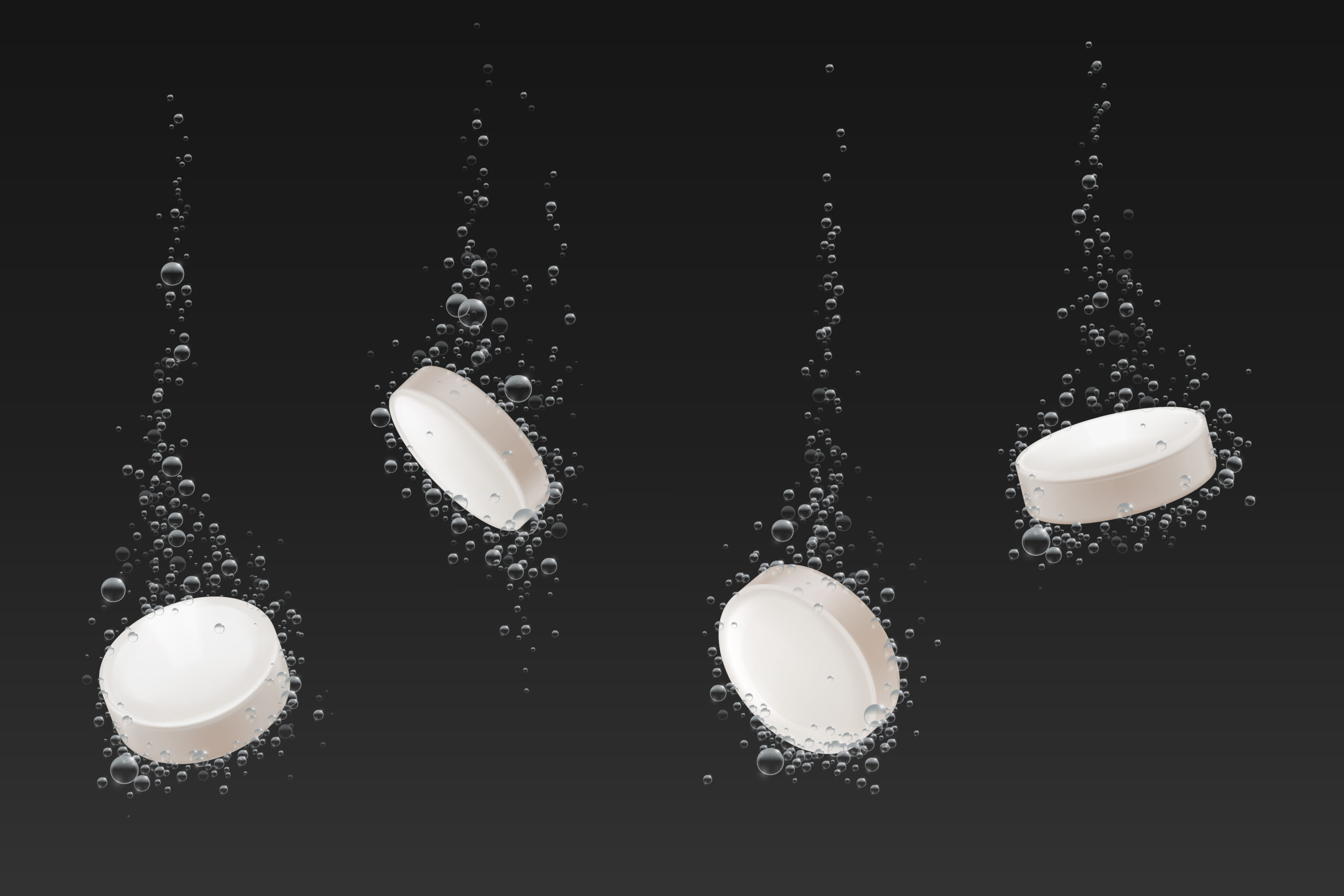Soluble pills with fizz air bubbles trail in water